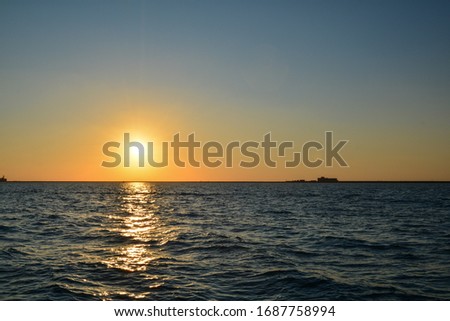 Sun setting over arabian sea showing texture of the waves
