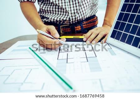 Architectural offiice site desk Solar cell background construction project ideas concept.Renewable energy