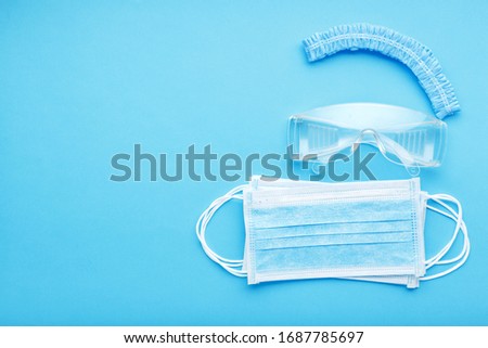 Medical Surgeon face protection kit for Medical Worker, doctors. Protective surgical face mask, glasses, hat. Protection prevention viral infection coronavirus, Covid-19. Concept medicine health care Royalty-Free Stock Photo #1687785697