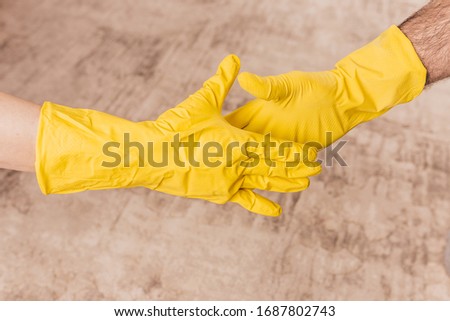 Tactile etiquette for the time of the coronavirus pandemic - rubber-gloved handshake - handshake prohibition