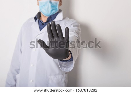 Young European doctor show stop hand gesture to stop Coronavirus or COVID-19 epidemic. Hand "NO" sign. White background.