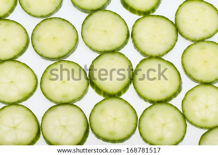 Freshly sliced cucumber  isolated on white background 