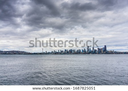 Dark storm clouds hover over the Seattle skyline.