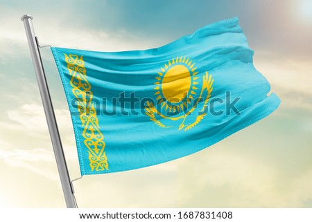 Kazakhstan national flag cloth fabric waving on the sky with beautiful sun light - Image