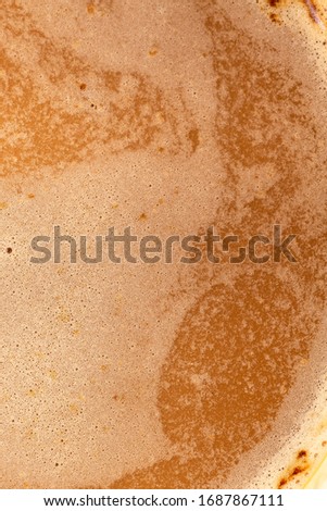 macro close-up coffee bubbles texture background, espresso foam, Macro tilt up of espresso coffee poured in a cup and swirling with its cream and aroma. Italian coffee and drink