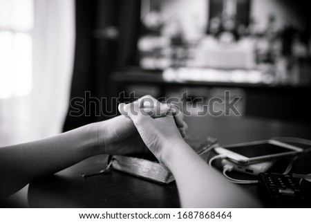 Woman praying and worship to GOD with church online sunday service.Live Church with bible.woman pray to GOD.Hand praying and palm up on holy bible at home.Quarantine from Covid-19 Coronavirus pandemic Royalty-Free Stock Photo #1687868464