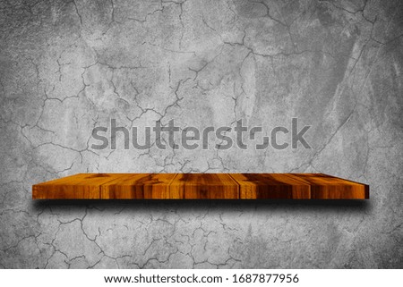 Empty wooden shelf on concrete wall background. For put product and some thing