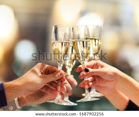 Celebration. People holding glasses of champagne making a toast. Champage with blurred background Royalty-Free Stock Photo #1687902256