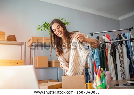 Woman Running Business From Home. Shipping shopping online, young start up small business owner packing cardboard box at workplace. Online selling or e-commerce. Royalty-Free Stock Photo #1687940857
