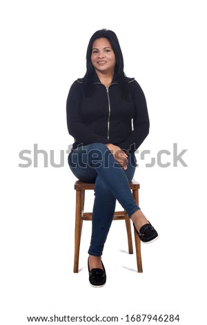 portrait of a woman sitting on a chair in white background, looking at camera