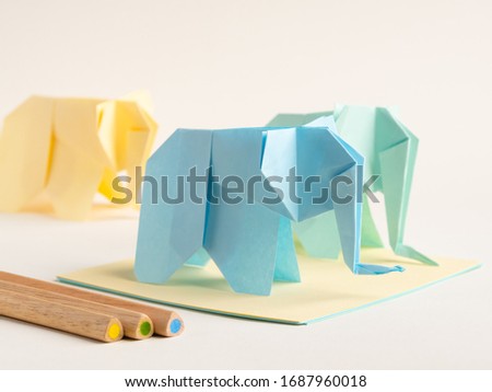 Origami animals. Colorful paper elephants made by children during quarantine. Useful home activities and learning ideas. What to do with children at home. Handmade toys. 