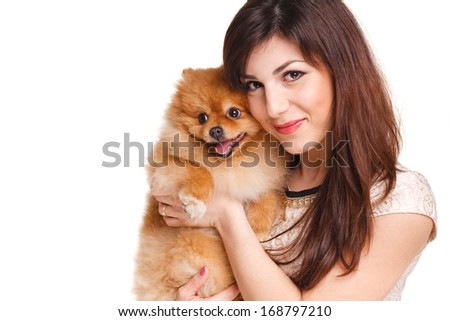 Happy woman and her beautiful little red dog spitz over white background close portrait