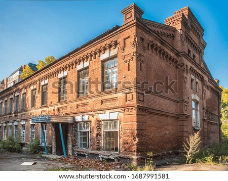 Beautiful view of an old brick residential building in retro style and vintage in the summer afternoon.