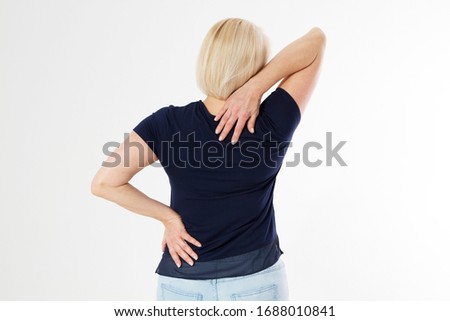 Woman female back ache, back pain, Female body showing pain in back spine.Medical concept,Middle age Woman standing in white and touching her back copy space