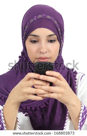 Arab woman writing a message addicted to the smart phone isolated in a white background              