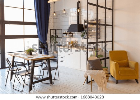 luxury modern design of a cozy small Scandinavian-style studio apartment with white walls, second floor with a library and huge high window Royalty-Free Stock Photo #1688043028
