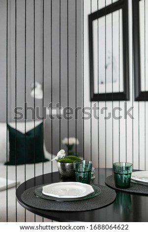 Small studio interior with set dinner table and bedroom area
