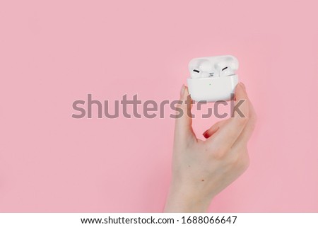 Air Pods pro apple. with Wireless Charging Case. New Airpods pro on pink background. Airpodspro. female headphones. wireless headphones in hand Royalty-Free Stock Photo #1688066647