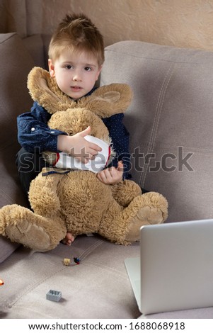 boy sits with a toy in a medical bandage