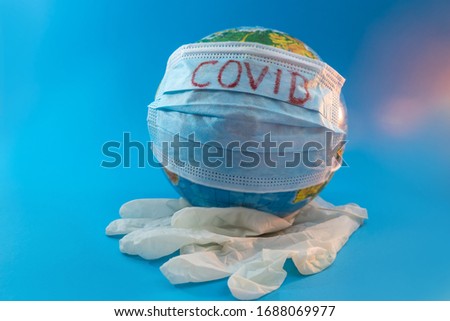 globe of planet dressed a medical mask with text Covid -19 worldwide epidemic. Coronavirus and quarantine planet infection pandemic concept