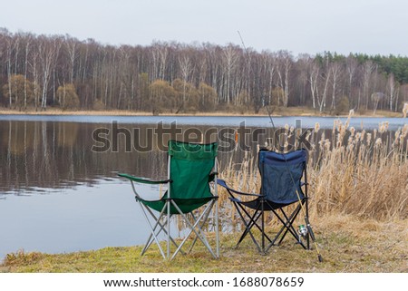 two armchairs and spinning on the shore of a beautiful lake, photo taken on a spring day