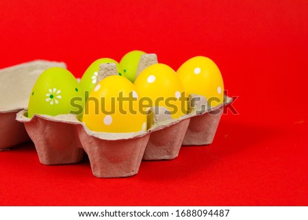 Colorful Easter eggs in a group with smiley face on a red background