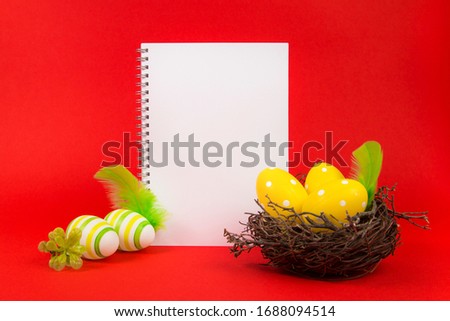 Yellow Easter eggs in a bird's nest on a red background