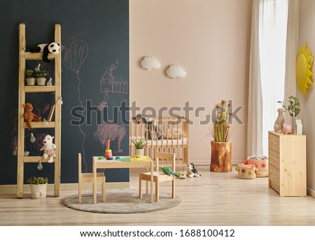 Modern baby room dark black board wall with chalk, wooden cabinet and cradle background.