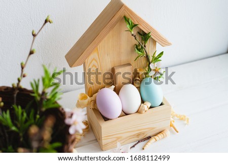 Happy Easter day. Easter decor. Painted eggs in a wooden house. Spring. Easter eggs.