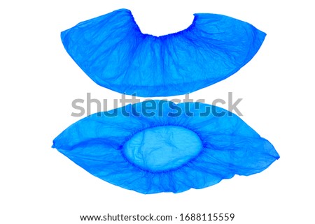 An isolated pair, two medical, blue, disposable Shoe covers on a white background. Shoe covers are located under each other. Top and side view. Royalty-Free Stock Photo #1688115559