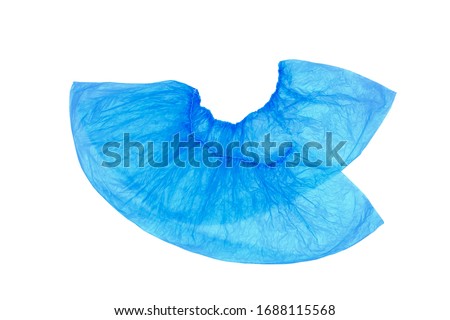An isolated pair, two medical, blue, disposable Shoe covers on a white background. Shoe covers are superimposed on each other with heels. Royalty-Free Stock Photo #1688115568
