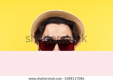 man in sunglasses and a panama hat holds an empty banner, summer billboard, mock-up image