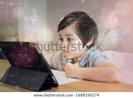 Preschool kid using tablet for his homework,Child doing homework by using digital taplet searching information on internet, E-Learning world connected,Social network concept