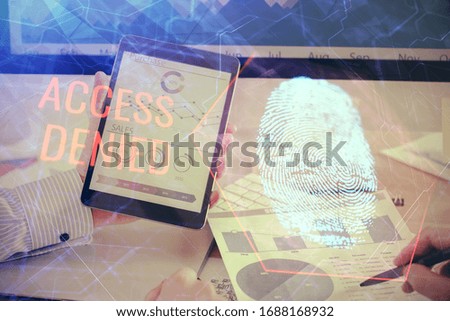 Double exposure of man's hands holding and using a digital device and fingerprint hologram drawing. Security concept.