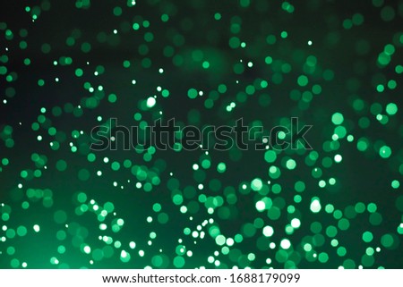 Abstract bokeh lights with light green background
