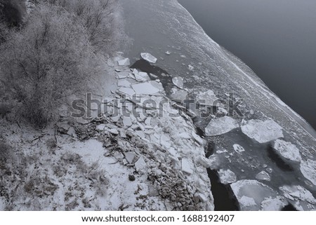 A strong and cold winter on the Danube River. The coast is under ice and snow