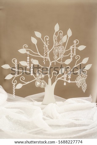 wedding details, earrings on a special stand in the form of a tree
