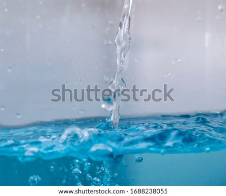 Water flows into a white background. Water splash, water splash isolated on white background, water