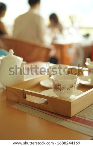 Cup, Bag Of Tea With Tea (different blank Label) on the table.