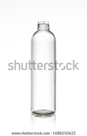 Clear transparent cosmetic bottle front view on white background studio photo for mockup design Royalty-Free Stock Photo #1688250622