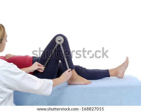 Physiotherapist measuring active range of motion of older patient's lower limb using manual goniometer