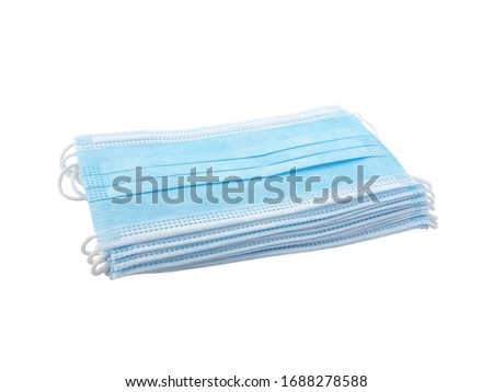 close up stack light blue surgical mask (medical face mask) with white rope strap for protective coronavirus (COVID-19) pandemic or PM2.5 dust particles isolated on white background Royalty-Free Stock Photo #1688278588