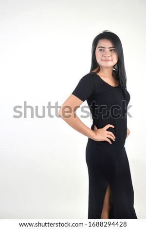 portrait of Beautiful Asian girl dressed in black photo shoot in a white background photo studio