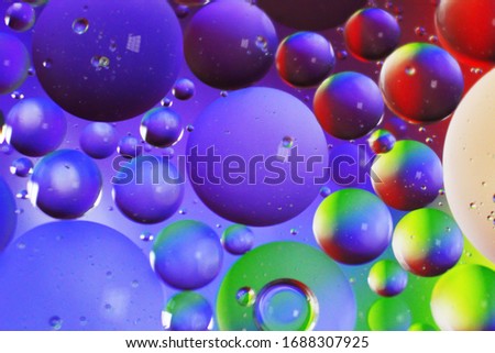 Micro image of Oil drops on water colourful background