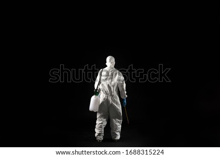 female virologist, she wears PPE.He stands back. Royalty-Free Stock Photo #1688315224
