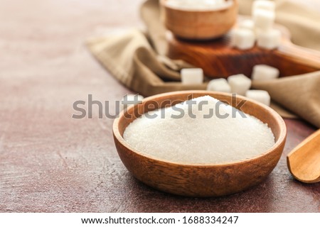 Plate with sweet sugar on color background Royalty-Free Stock Photo #1688334247