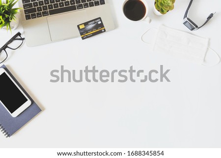 Flat lay of work from home, workspace with laptop and smartphone, credit card shopping online concept to prevent epidemic 