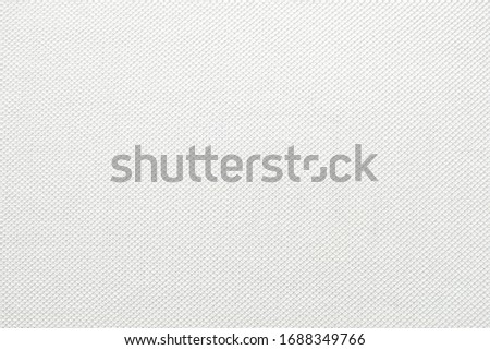 White fabric close up shot of Cotton and polyester shirt. Casual wear over the weekend or summer time season. Background texture concept with copy space for text. Royalty-Free Stock Photo #1688349766