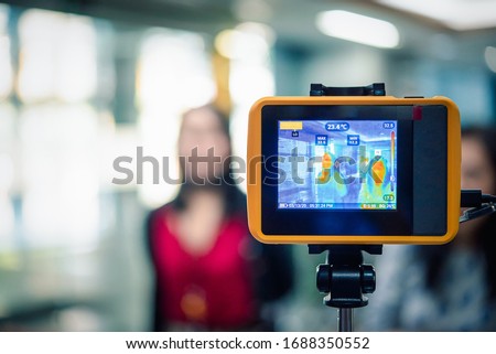 Asian people waiting for body temperature check before access to building for against epidemic flu covid19 or corona virus from wuhan in office by thermoscan or infrared thermal camera Royalty-Free Stock Photo #1688350552