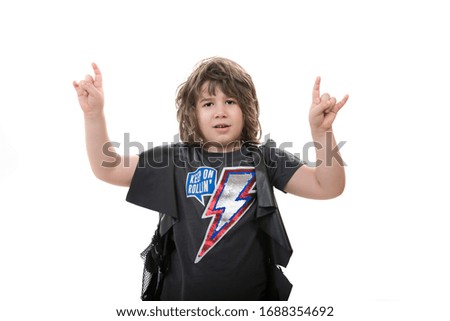 Rocker kid boy showing rock and roll sign fingers isolated on white background